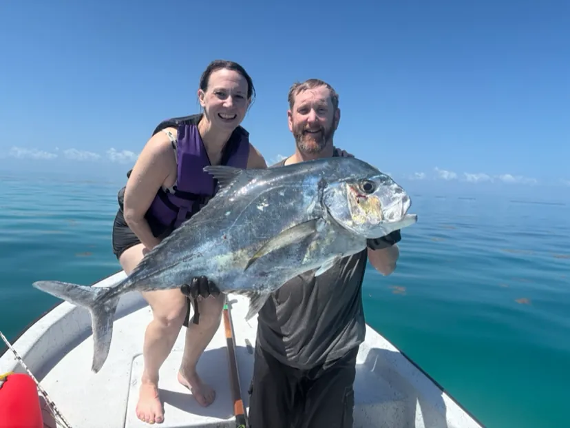Couple holding a big jack on the bow