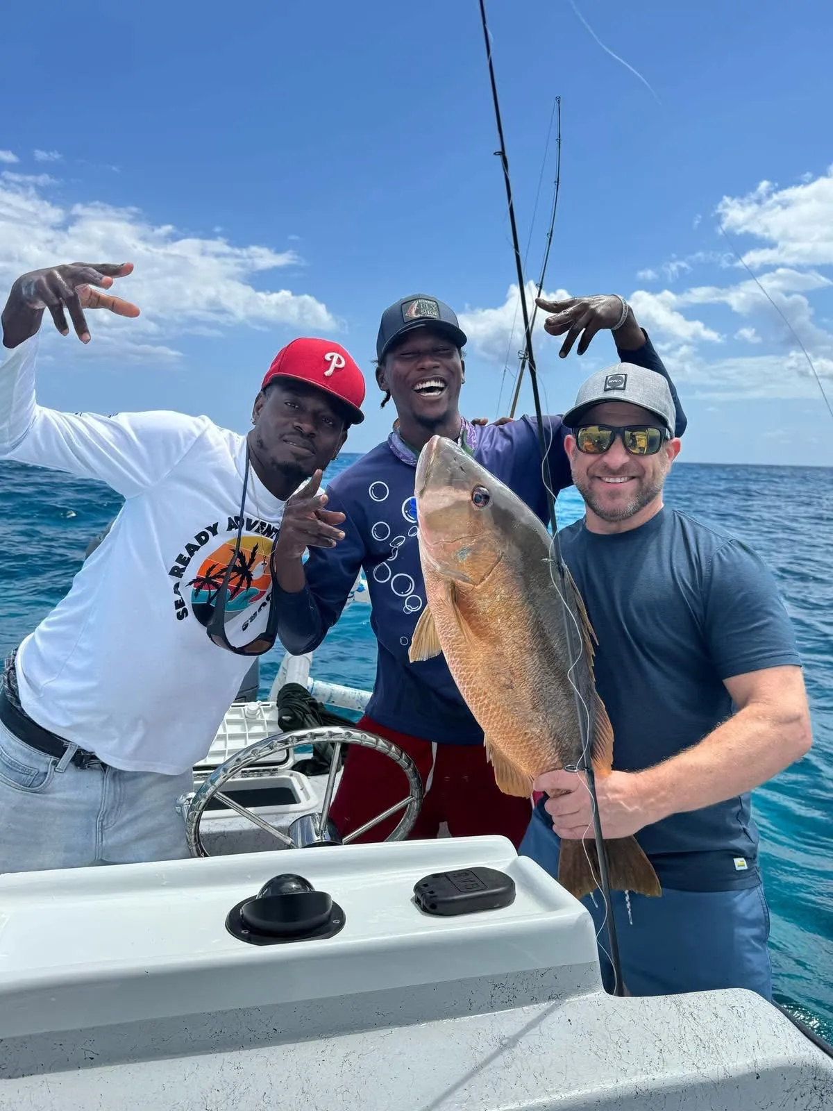 Crew and guest with a mutton snapper