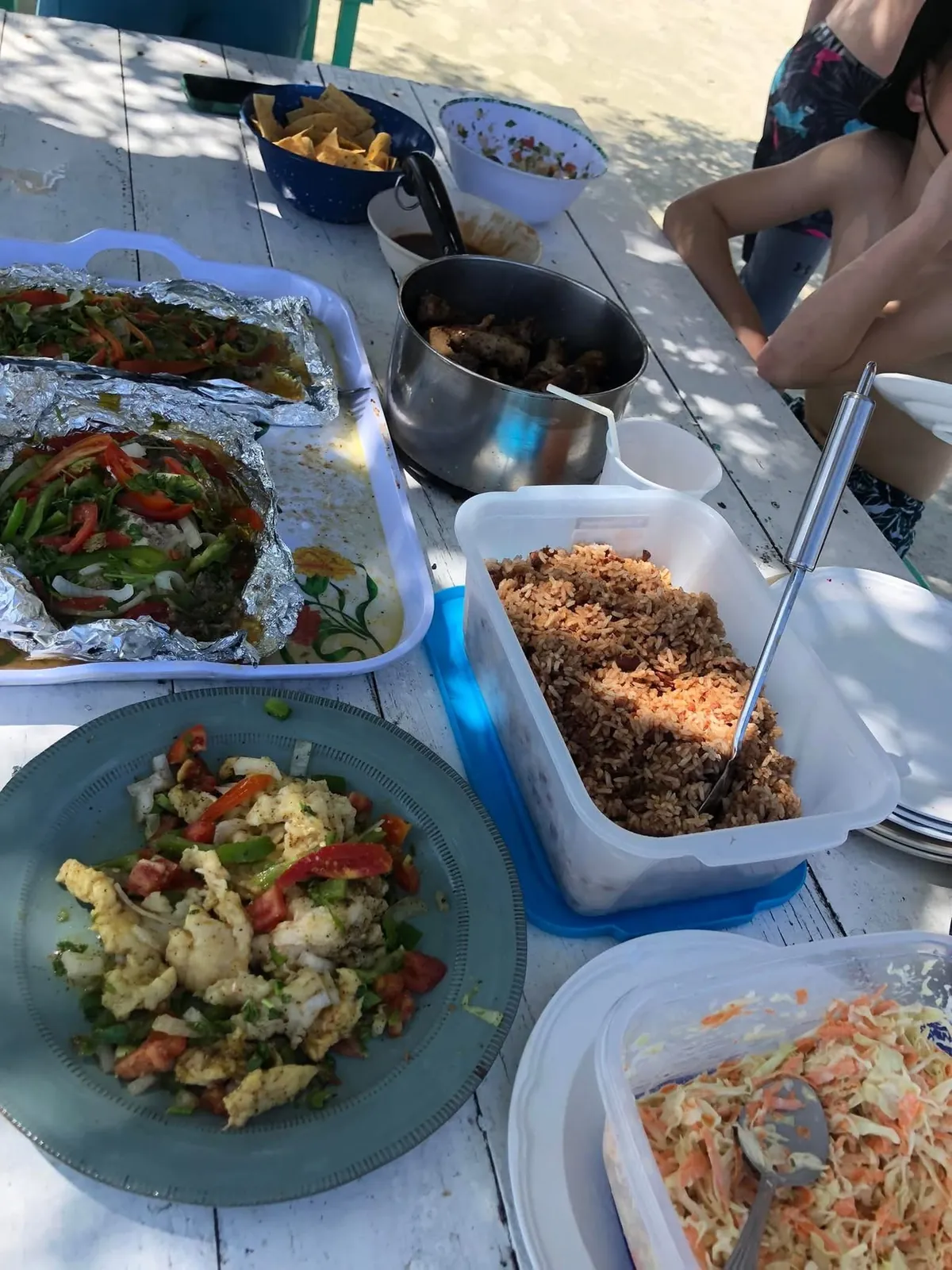 Beach lunch of foil-grilled fish, rice and beans and slaw on a Belize caye